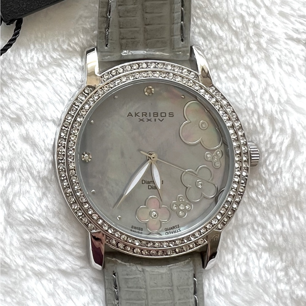 Akribos XXIV Grey Women’s watch w/grey leather band, silver floral face. NWT